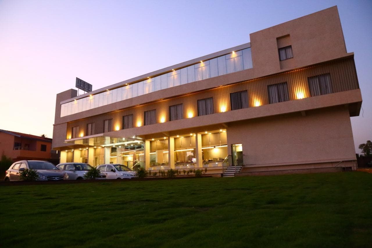 Hotel Triveni at dusk, seen across the lawn